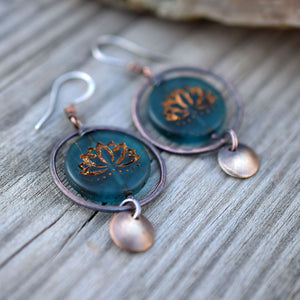 Copper hoop earrings with blue glass lotus beads at the center with golden highlights. Brass circle dangles. Bohemian Style Earrings that are handmade.