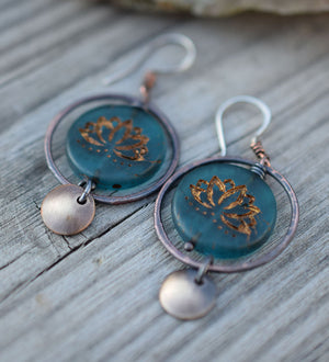 Copper hoop earrings with blue glass lotus beads at the center with golden highlights. Brass circle dangles. Bohemian Style Earrings that are handmade.