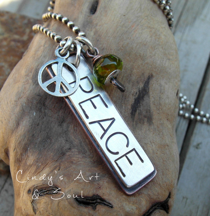 Handmade necklace with a bold PEACE loving charm. Peace sign and artist handmade lampwork bead. 